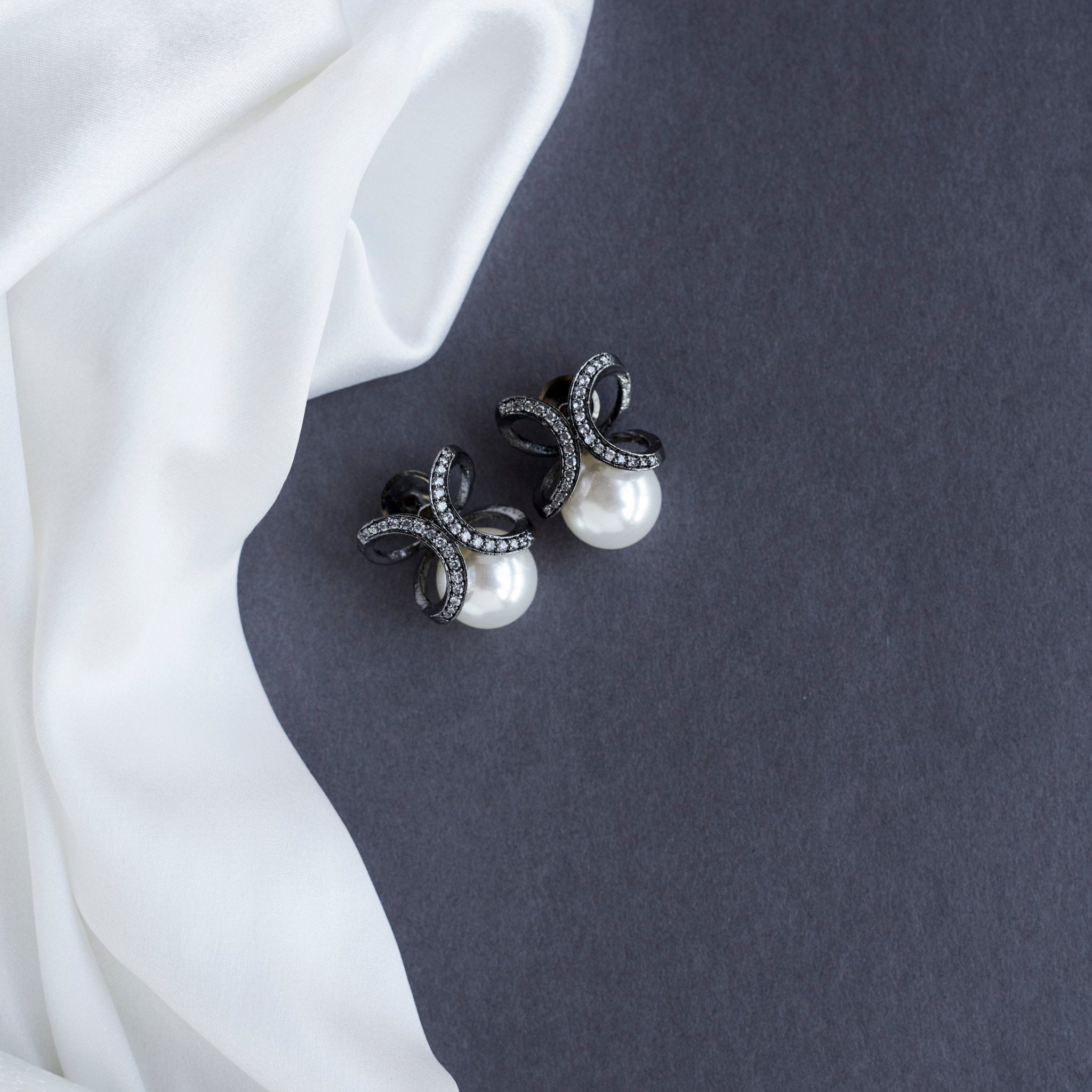 Black Plated Bow Design American Diamond Pearl Stud Earrings